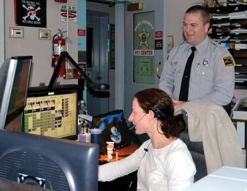 Sara Finch (left) assists K.S. Libby, (Trooper, NC Highway Patrol) by performing a data search on a driver’s records.