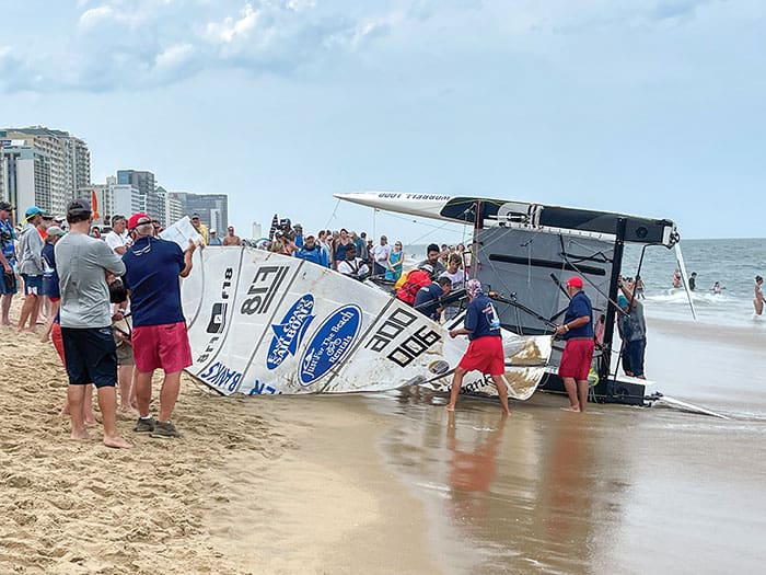 Team Outer Banks beached and, on its side, after limping across the Worrell 1000 finish line at Virginia Beach. James Eaton & Hardy Peters were forced to purposefully capsize their vessel at the conclusion of the race, after discovering equipment damage had occurred on the final leg.