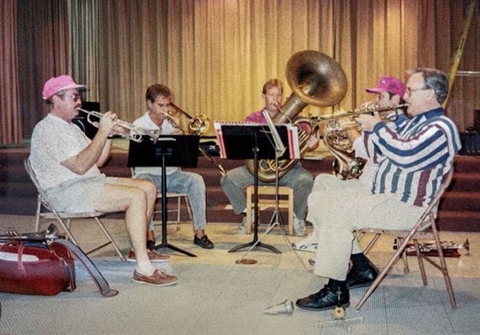 Local performers helped bolster offerings by the Forum in the early years. In this photo, Brass Menagerie, a brass quintet, rehearses before an upcoming 1993 holiday performance for the Outer Banks Forum. The professionally trained local musicians included Ken Forney (trumpet), Jerry Manolas (trombone), Dock Sawyer (tuba), Roy Murray (French Horn), and Rowland Shock (trumpet).