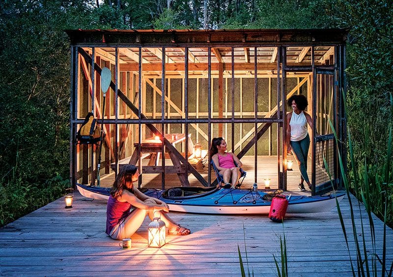 Kayakers on Little Washington’s Tar-Pamlico Water Trail enjoying a picnic platform at dusk.Courtesy of VisitNC.com